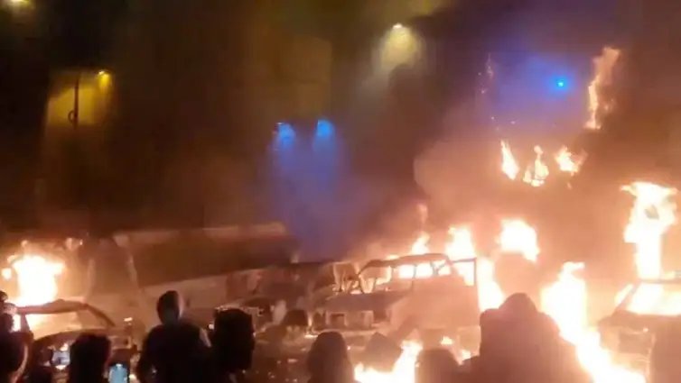 Protesters gather as vehicles burn, amid evolving anti-government unrest, in Tehran, Iran, in this screen grab obtained from a social media video released on January 9, 2026. Social Media/via REUTERS  THIS IMAGE HAS BEEN SUPPLIED BY A THIRD PARTY. NO RESALES. NO ARCHIVES. REFILE - QUALITY REPEAT  VERIFICATION: - Buildings, business signage and traffic light matched file and satellite imagery - Date not verified - Witnesses told Reuters protesters gathered in the streets on Thursday (January 8)