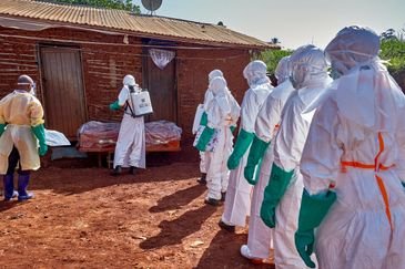 Red Cross workers wearing personal protective equipment (PPE) disinfect the house of an unidentified man who died of Ebola before retrieving his body, as aid agencies intensify efforts to contain a new Ebola outbreak involving the Bundibugyo strain, in Quartier Shuni 1, a residential sector in Mongbwalu, Djugu Territory of Ituri province, Democratic Republic of Congo, May 24, 2026. REUTERS/Gradel Muyisa Mumbere     TPX IMAGES OF THE DAY